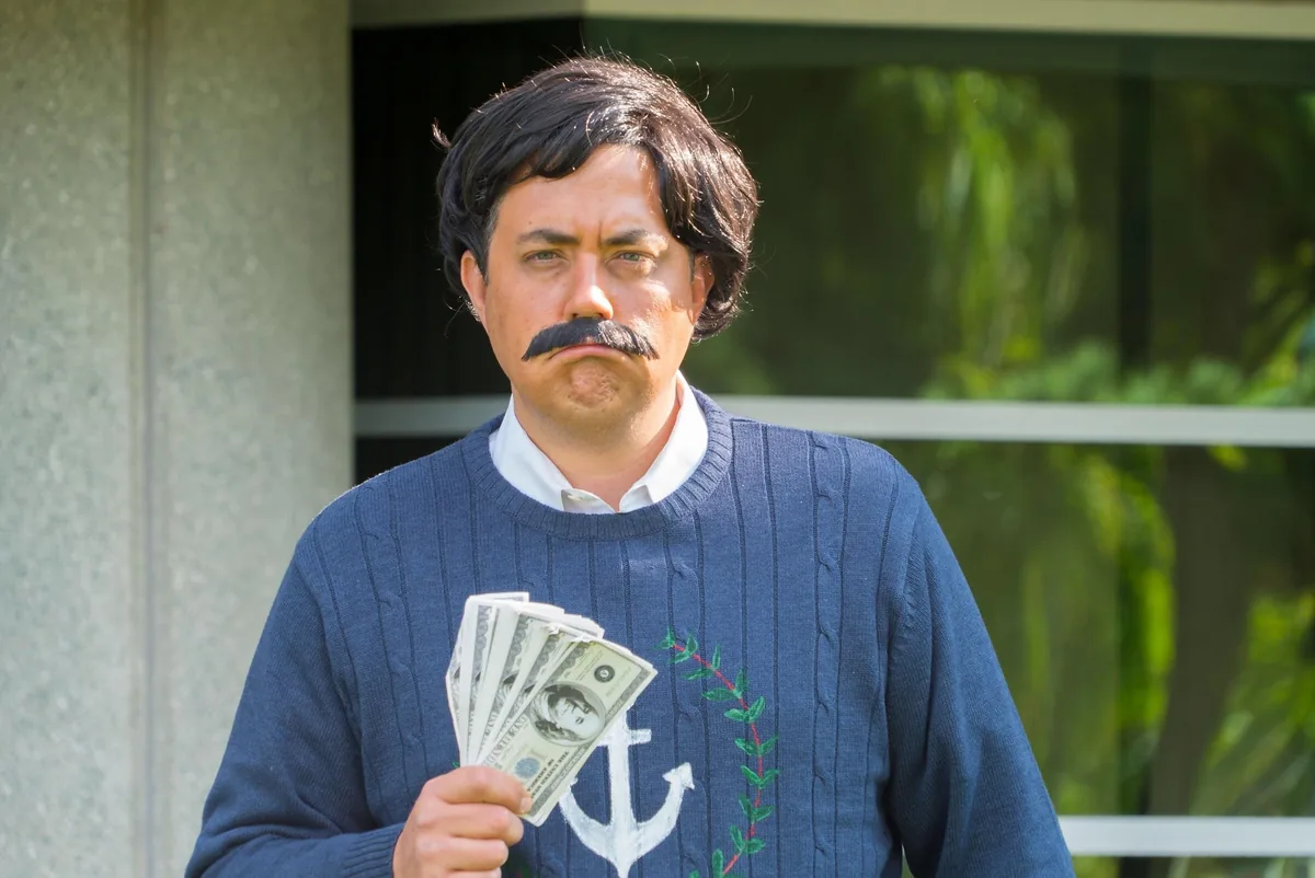 Keno Vigil in a Halloween costume holding prop cash