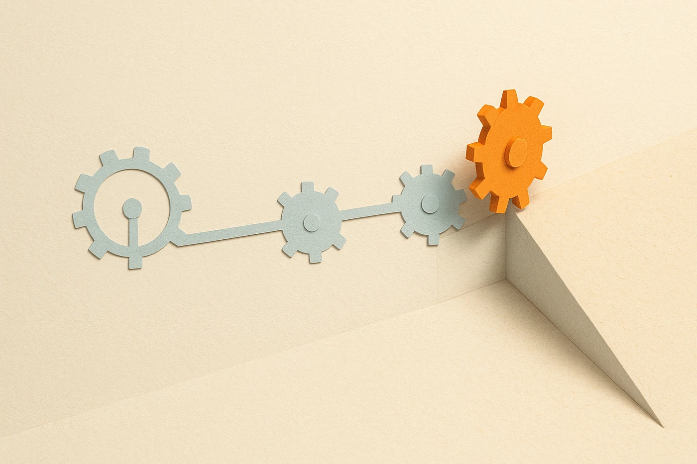 Cut-paper illustration of a pale blue flat gear-and-linkage schematic in a clean row on the left half of the frame, folding at a visible crease into a shaded, textured physical half on the right, one orange gear straddling the fold, mid-turn
