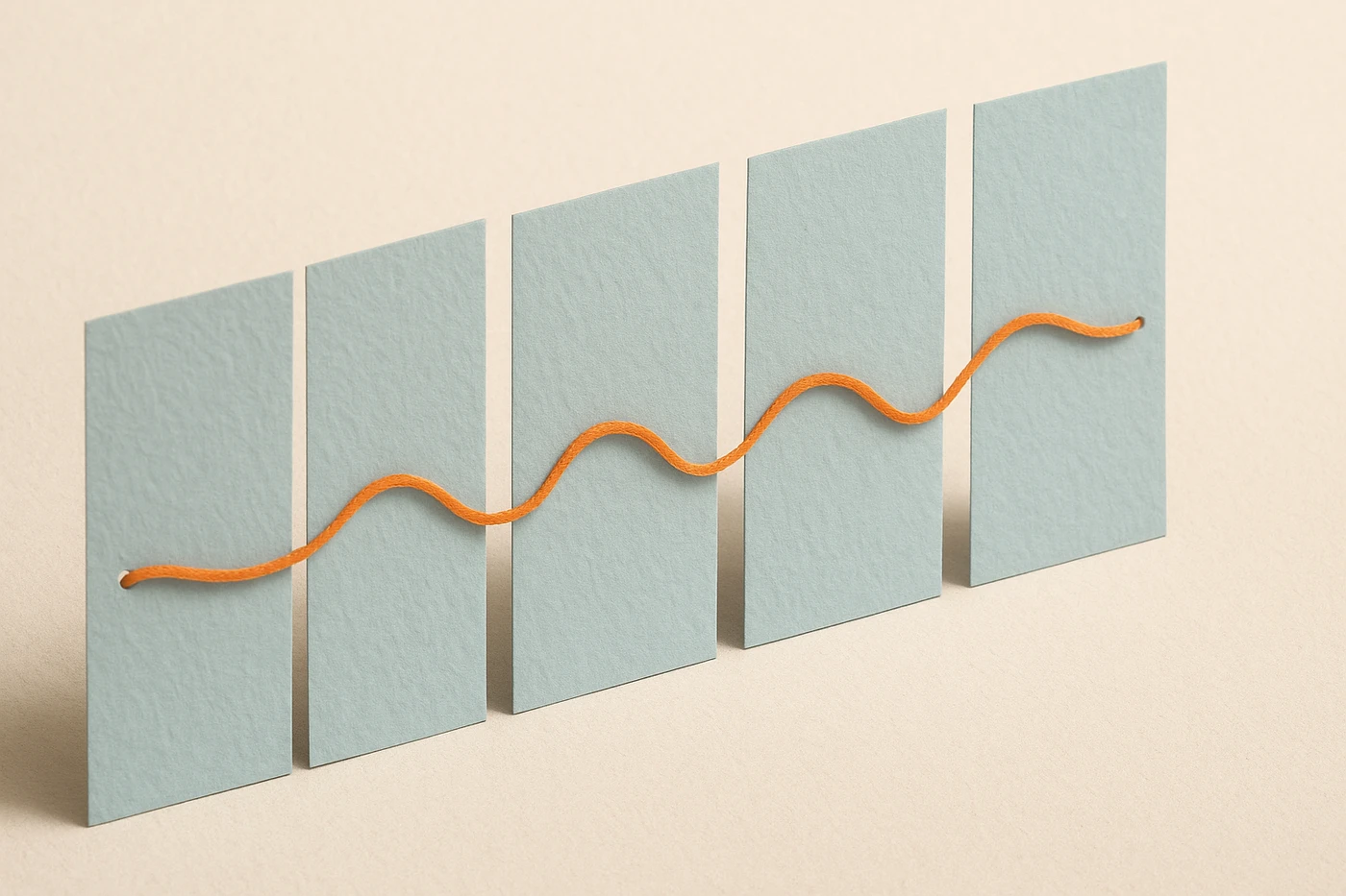 Cut-paper illustration of five pale blue paper panels in a row, a single orange thread passing in and out of each one from left to right